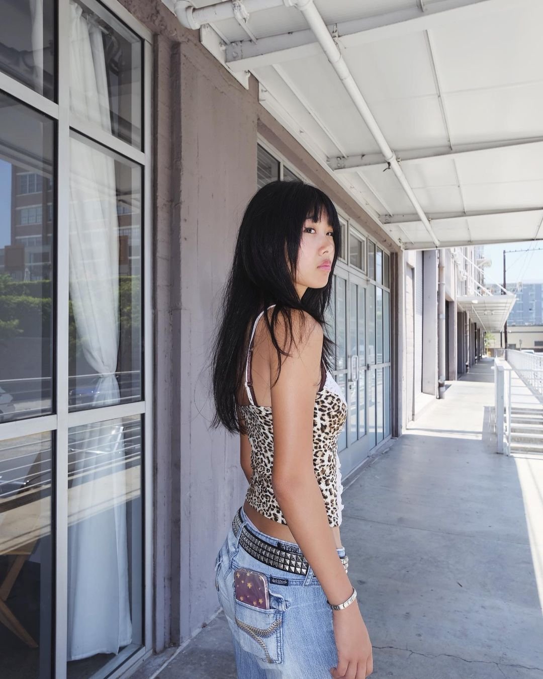 Medium-length, black straight hair with blunt bangs and face-framing layers, featuring a smooth, layered cut. 4