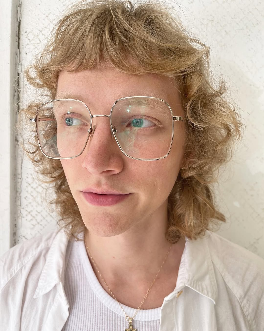 Medium-length, honey gold curls with a soft fringe and layered for volume, creating a retro and casual elegant look. 1